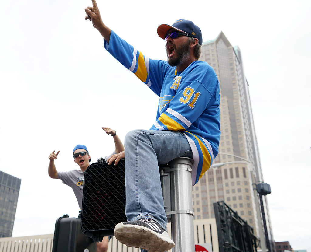 Zach Lehman, left, and Ted Weinkamp celebrate the Blues' Stanley Cup victory atop pedestrian street signals